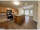 Kitchen with island, stainless steel appliances, and granite countertops at 9585 Lakeview Cir, Union City, GA 30291