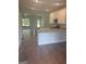 Open concept kitchen with an island, granite countertops, and hardwood floors at 1921 School House Ln, Temple, GA 30179