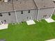 Aerial view of townhouses with backyard patios and lawn at 1921 School House Ln, Temple, GA 30179