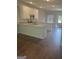 Modern kitchen with white cabinets, granite countertops, and dark hardwood floors at 1921 School House Ln, Temple, GA 30179