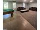 Spacious basement recreation area with pool table and seating at 938 Mulberry Fields Cv, Auburn, GA 30011