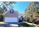 Brick house with a two-car garage and well-manicured lawn at 938 Mulberry Fields Cv, Auburn, GA 30011