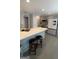 Modern kitchen with gray cabinets, stainless steel appliances, and breakfast bar at 938 Mulberry Fields Cv, Auburn, GA 30011