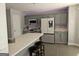 Updated kitchen with gray cabinets, stainless steel appliances, and breakfast bar at 938 Mulberry Fields Cv, Auburn, GA 30011
