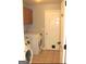 Laundry room with washer, dryer, and cabinets at 938 Mulberry Fields Cv, Auburn, GA 30011