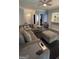 Comfortable living room with sectional sofa and view into dining area at 938 Mulberry Fields Cv, Auburn, GA 30011