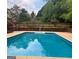 Relaxing in-ground pool, surrounded by lush greenery at 938 Mulberry Fields Cv, Auburn, GA 30011