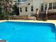Inviting in-ground pool with deck and fenced backyard at 938 Mulberry Fields Cv, Auburn, GA 30011