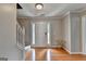 Hardwood floor entryway with staircase and a white door at 3285 Watson Gate Rd, Loganville, GA 30052