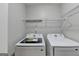 Bright laundry room with Samsung washer and dryer and ample shelving at 3285 Watson Gate Rd, Loganville, GA 30052