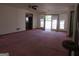 Large living room with pink carpet and access to backyard at 402 Thurman Rd, Stockbridge, GA 30281