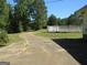 Curved driveway with a view of the home and fenced pool area at 402 Thurman Rd, Stockbridge, GA 30281