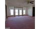 Spacious living room with pink carpet and French doors at 402 Thurman Rd, Stockbridge, GA 30281