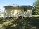 Yellow house exterior with window and AC unit at 402 Thurman Rd, Stockbridge, GA 30281