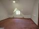 Large bedroom with sloped ceilings and window at 402 Thurman Rd, Stockbridge, GA 30281