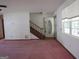Living area showcasing staircase and front entrance at 402 Thurman Rd, Stockbridge, GA 30281