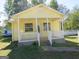 Yellow house with front porch and white railing at 402 Thurman Rd, Stockbridge, GA 30281