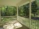 Covered porch with white railings and view of the backyard at 402 Thurman Rd, Stockbridge, GA 30281