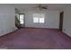 Living room with pink carpet, showing staircase and front door at 402 Thurman Rd, Stockbridge, GA 30281