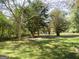 Landscaped side yard with a paved walkway at 402 Thurman Rd, Stockbridge, GA 30281