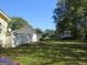 Large grassy side yard with a white fence and RV parking at 402 Thurman Rd, Stockbridge, GA 30281