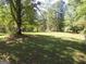 Spacious backyard with lush green grass and large trees at 402 Thurman Rd, Stockbridge, GA 30281