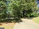 Long driveway leading to a charming yellow house at 402 Thurman Rd, Stockbridge, GA 30281