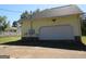 Detached garage with a large white door and a concrete driveway at 402 Thurman Rd, Stockbridge, GA 30281