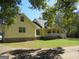 Ranch style home with a yellow exterior and green roof at 402 Thurman Rd, Stockbridge, GA 30281