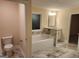 Bathroom with soaking tub, marble tile, and vanity at 200 Parker Dr, Mcdonough, GA 30253