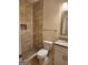 Modern bathroom with beige tiles, a shower, and granite countertop at 200 Parker Dr, Mcdonough, GA 30253