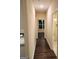 Long hallway with dark hardwood floors and access to bathroom at 200 Parker Dr, Mcdonough, GA 30253