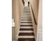 Elegant staircase with dark wood treads and white risers at 200 Parker Dr, Mcdonough, GA 30253