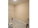 Bright laundry room, featuring tile flooring, and ample shelving at 200 Parker Dr, Mcdonough, GA 30253