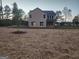 Tan two-story house with backyard and landscaping at 200 Parker Dr, Mcdonough, GA 30253