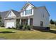 Two-story house with stone and beige siding at 502 Hinton Farm Way, Dacula, GA 30019