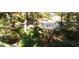 Overlooks a wooded, landscaped backyard from stairs at 5260 Island Dr, Stone Mountain, GA 30087