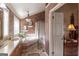 Elegant bathroom with a corner soaking tub, double vanity, and decorative tile at 5260 Island Dr, Stone Mountain, GA 30087