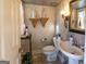 Elegant powder room with decorative wall finishes and a pedestal sink at 5260 Island Dr, Stone Mountain, GA 30087
