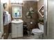 Small bathroom with white vanity, toilet and decorative accents at 5260 Island Dr, Stone Mountain, GA 30087