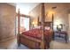 Bedroom with a four-poster bed, and a view of the attached bathroom at 5260 Island Dr, Stone Mountain, GA 30087
