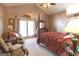 Bright bedroom with a four-poster bed, access to balcony, and sitting area at 5260 Island Dr, Stone Mountain, GA 30087