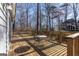 Spacious wooden deck with seating area, overlooks wooded backyard at 5260 Island Dr, Stone Mountain, GA 30087