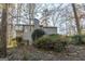 Two-story house with gray siding and wooded setting at 5260 Island Dr, Stone Mountain, GA 30087