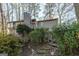 Gray house nestled in woods with stone pathway at 5260 Island Dr, Stone Mountain, GA 30087