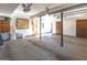Two-car garage with overhead storage and an interior door at 5260 Island Dr, Stone Mountain, GA 30087