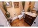 Stylish powder room with ornate vanity and hardwood floors at 197 Westbrook Rd, Carrollton, GA 30116