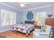 Bedroom with hardwood floors, light blue walls, and a ceiling fan at 230 Haynes Rd, Moreland, GA 30259