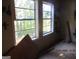 Unfinished bedroom with two windows and graffiti at 4592 Ruby Rd, Stone Mountain, GA 30083