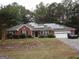 Brick ranch home with solar panels, two-car garage and manicured landscaping at 2958 Mary Alice Trl, Loganville, GA 30052